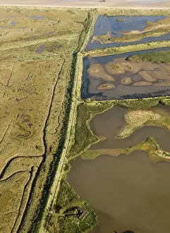 Coast Prints: Aerial view of saltmarsh and lagoons at Titchwell RSPB Reserve North Norfolk autumn