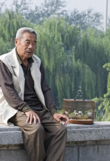 China Prints: Bird keeper in Beijing China with Marsh Tit in cage