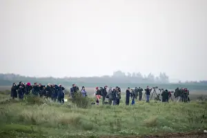 Birdwatchers watching waders over the Wash at Snettisham RSPB Reserve Norfolk winter