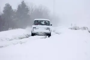Journey Prints: Car travelling along snow covered road during blizzard on route to Kazbegi Great