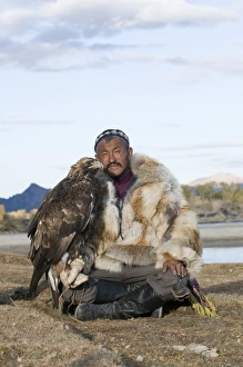 Dalai Han an Kazakh eagle hunter with his Golden Eagle Bayan Ulgii in Altai Mountains