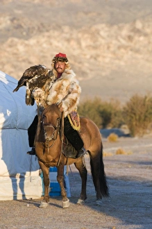 Kazakh eagle hunter with his Golden Eagle Uglii in Altai Mountains western Mongolia