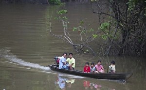 Family on tributary of River Amazon Nr Iquitos Peru
