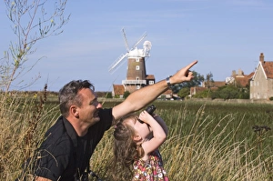 Father and daughter birdwatching at Cley North Norfolk August