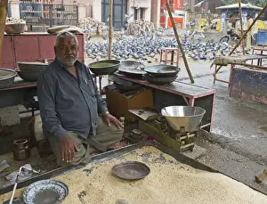 Bird Prints: Hindu grain seller for pigeon feeding for religious purposes Jodphur India