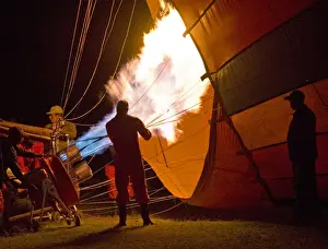 Inflating a hot air balloon prior to dawn in Masai Mara Kenya