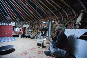 Kazakh eagle hunter inside his Ger with his Golden Eagle near Bayan-Ulgii in Altai Kazakh eagle hunter inside his Ger with his Golden Eagle near Bayan-Ulgii in Altai