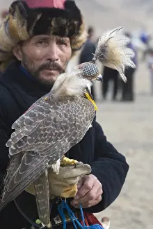 Kazakh hunter with Saker Falcon at Eagle hunters festival near Ulgii in western Mongolia
