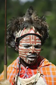 Kenya Prints: Kikuyu warrior wearing headress made of Helmeted Guineafowl feathers Tomson Falls Kenya