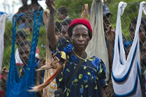 Lady in market with male Raggiana Bird of Paradise for sale Mt Hagen Papua New Guinea Lady in market with male Raggiana Bird of Paradise for sale Mt Hagen Papua New Guinea