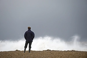 Man looking out across a rough North Sea off Cley Norfolk November Man looking out across a rough North Sea off Cley Norfolk November