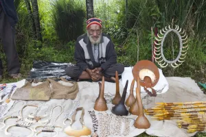 Pacific Prints: Man selling Penis gourds, pig tusks and various other items at Paiya Show Western