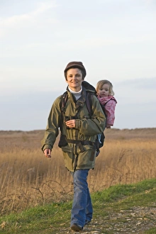mother carrying toddler in backpack while bird watching along coastal path North mother carrying toddler in backpack while bird watching along coastal path North