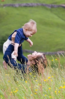 Mother and ten month old boy in field in summer UK Mother and ten month old boy in field in summer UK