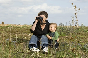 Mother and toddler looking at birds on a windy day at Snettisham RSPB Reserve North Mother and toddler looking at birds on a windy day at Snettisham RSPB Reserve North