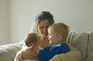 Images Dated 15th August 2006: Mother with toddler and new born girl on sofa at home Norfolk UK