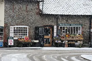 Cley Prints: Picnic Fayre shop in falling snow Cley Norfolk in winter