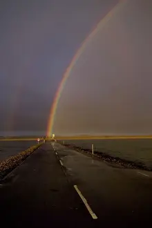 Trending: Rainbow over Lindisfarne causeway Holy Island Northumberland autumn