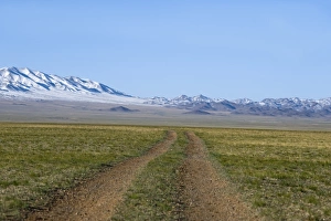 Road across the Gobi Desert below Altai Mountains within Gobi National Park Mongolia Road across the Gobi Desert below Altai Mountains within Gobi National Park Mongolia