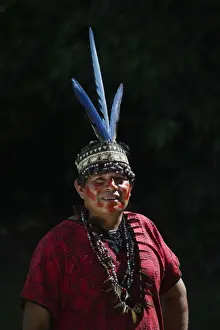 Shamans assistant from Bora Tribe wearing Macaw feather head dress Northern Amazon