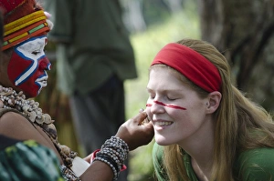 Tourist having her face painted at Sing-sing - The Paiya Show in Western Highlands Tourist having her face painted at Sing-sing - The Paiya Show in Western Highlands