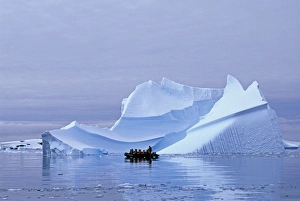 Tourists on Zodiac cruise around icebergs on the Antarctic Peninsula, Antarctica, January Tourists on Zodiac cruise around icebergs on the Antarctic Peninsula, Antarctica, January