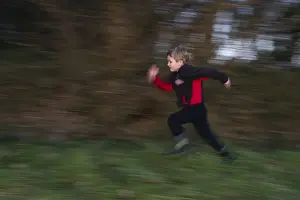 People Prints: Young boy playing in woodland in winter Norfolk December